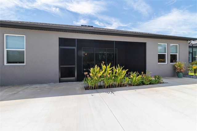 exterior space featuring a sunroom and a patio area