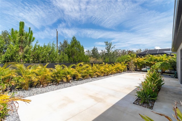 view of patio with glass enclosure