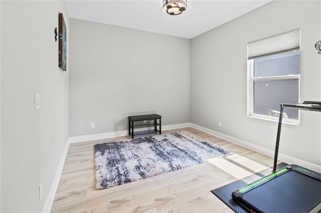 exercise room with hardwood / wood-style flooring