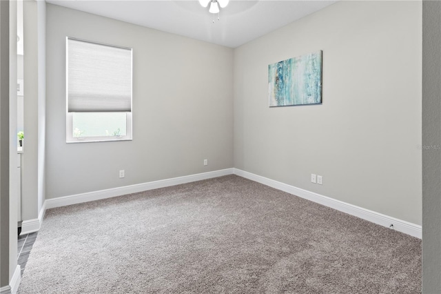 carpeted spare room with ceiling fan