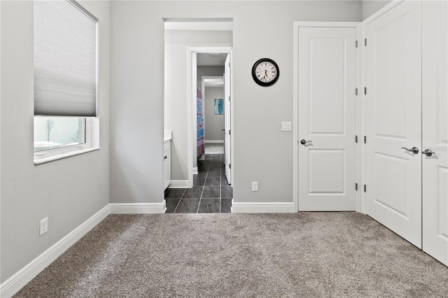 unfurnished bedroom featuring dark carpet