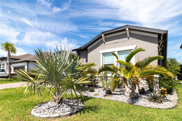 view of side of property with a lawn