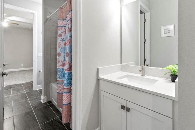 bathroom featuring tile patterned floors, ceiling fan, shower / bath combo with shower curtain, and vanity