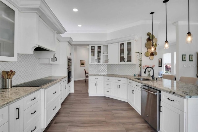 kitchen featuring black electric cooktop, white cabinetry, stainless steel dishwasher, and decorative light fixtures