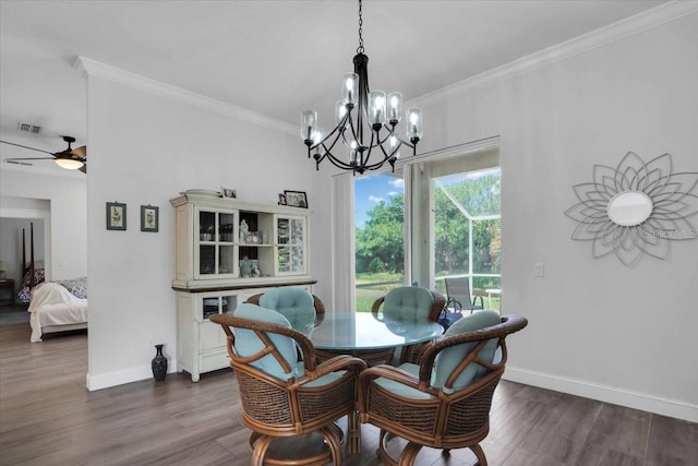 dining space featuring ceiling fan with notable chandelier, dark hardwood / wood-style floors, and crown molding