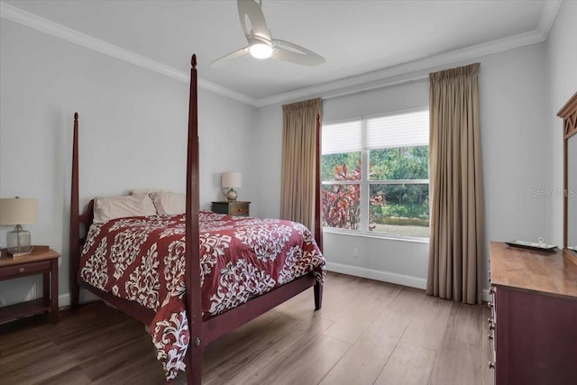 bedroom with hardwood / wood-style floors, ceiling fan, and ornamental molding