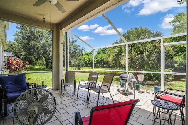 view of patio / terrace with ceiling fan and a lanai