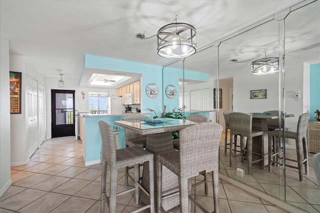 tiled dining space with a skylight