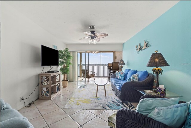 living room with ceiling fan and light tile patterned floors