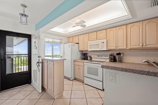 kitchen with ceiling fan, backsplash, white appliances, and a tray ceiling