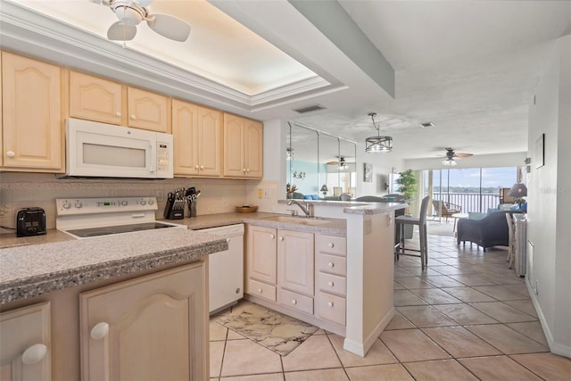 kitchen featuring sink, light tile patterned floors, kitchen peninsula, white appliances, and ceiling fan