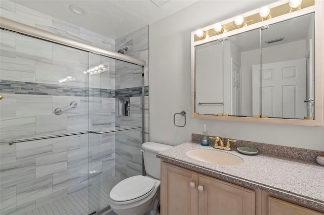 bathroom featuring toilet, walk in shower, and vanity