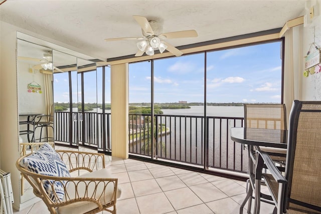 sunroom / solarium with plenty of natural light and ceiling fan