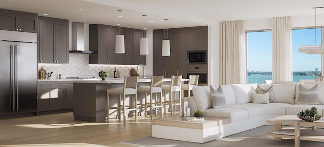 living room with sink, hardwood / wood-style flooring, and a water view