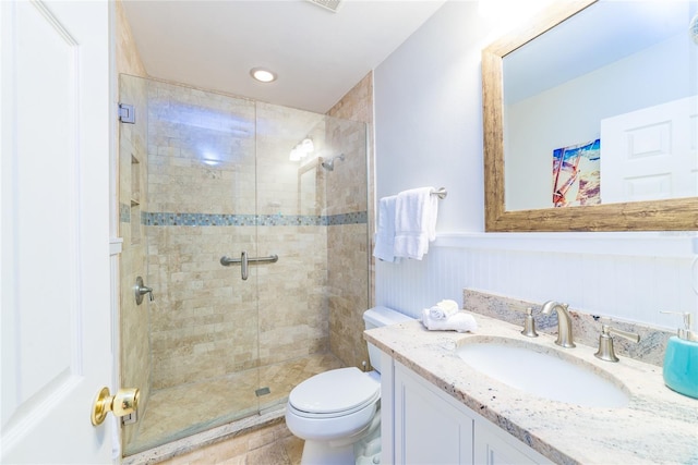 bathroom featuring vanity, toilet, and walk in shower