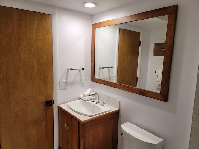 bathroom featuring vanity and toilet