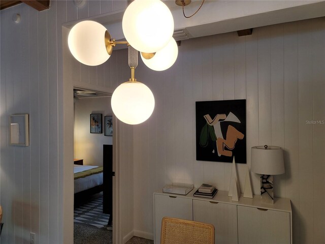 interior space featuring beamed ceiling, carpet flooring, and wood walls