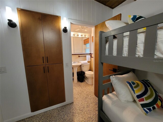 bathroom featuring toilet and speckled floor