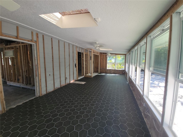 interior space with a skylight and a ceiling fan