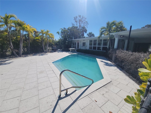 pool with fence and a patio area