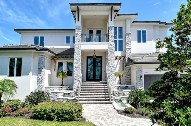 view of front of house with a balcony and a garage