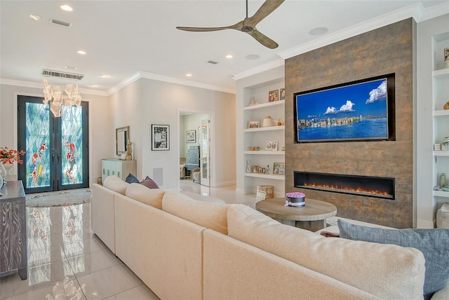 living room with crown molding, ceiling fan, built in features, light tile patterned floors, and a large fireplace