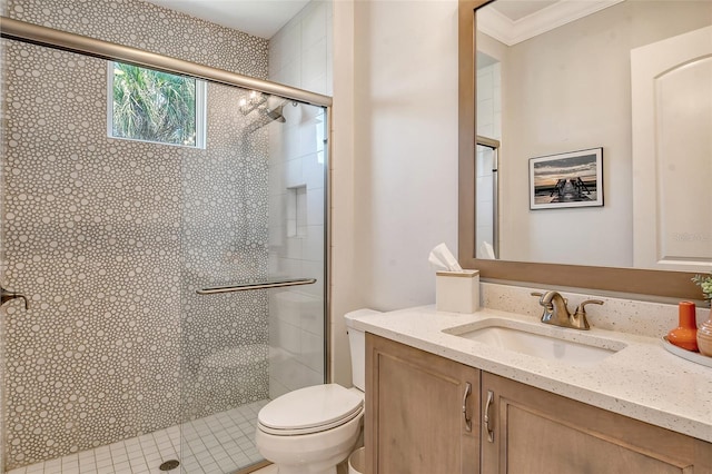 bathroom with crown molding, vanity, a shower with shower door, and toilet