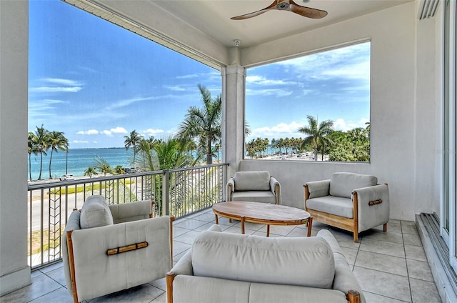 view of patio / terrace with ceiling fan, a water view, and a balcony