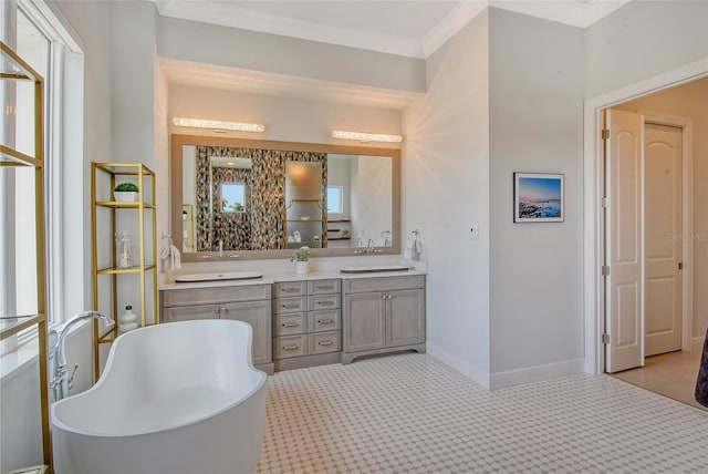 bathroom featuring vanity, crown molding, and a tub to relax in