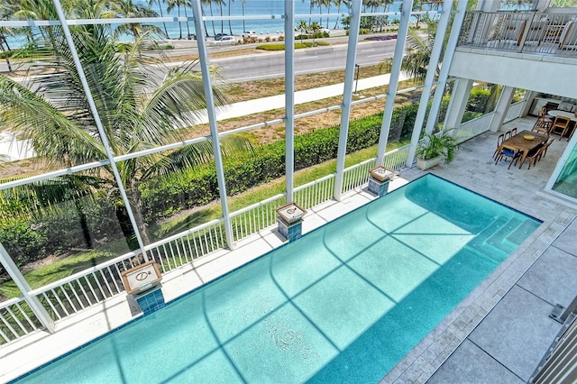 view of pool with a water view