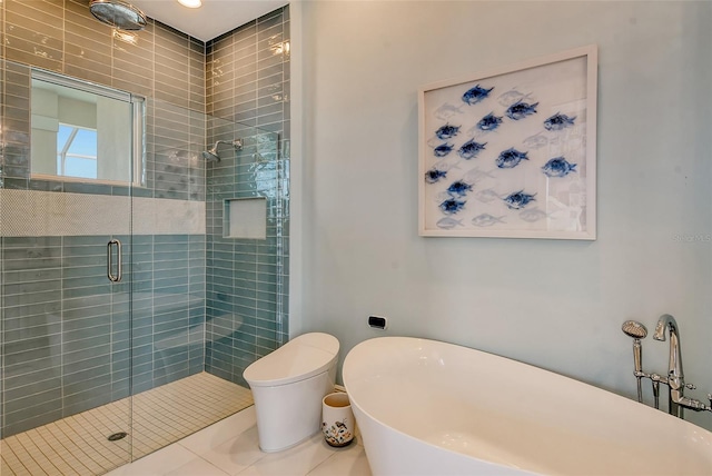 bathroom featuring tile patterned flooring, a shower with shower door, and toilet