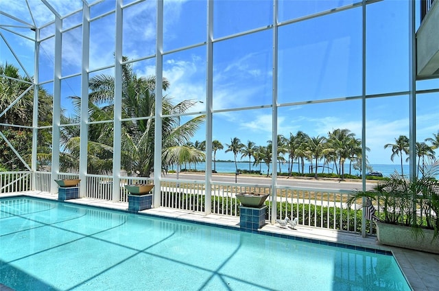 view of swimming pool with a water view and a lanai