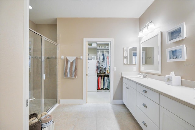 bathroom featuring tile patterned floors, vanity, and a shower with door