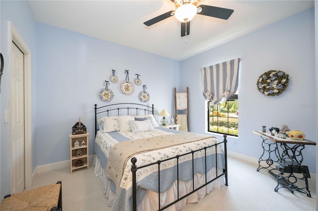 bedroom featuring ceiling fan and light carpet