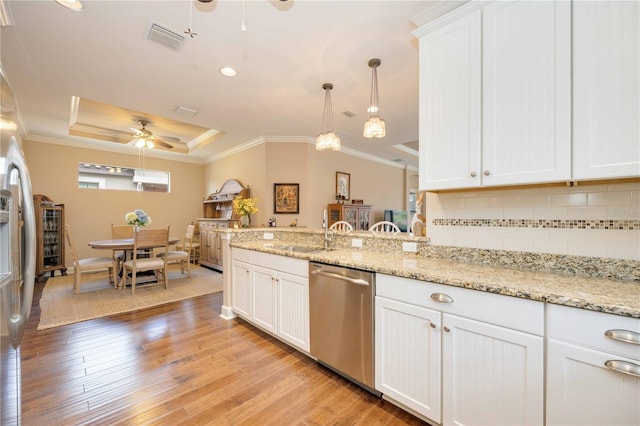 kitchen with light wood-type flooring, stainless steel appliances, and white cabinetry