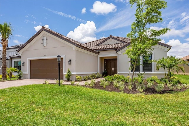 mediterranean / spanish-style house featuring a garage and a front lawn