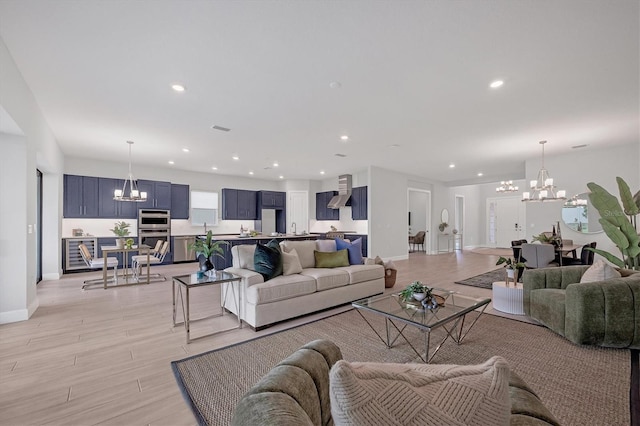 living room featuring a chandelier and light hardwood / wood-style floors