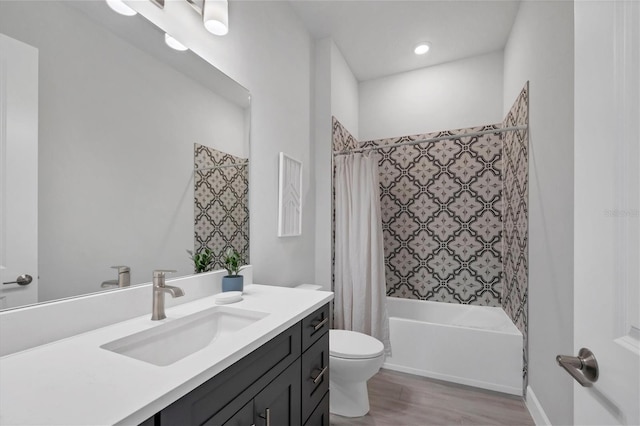 full bathroom featuring vanity, toilet, shower / bathtub combination with curtain, and hardwood / wood-style flooring