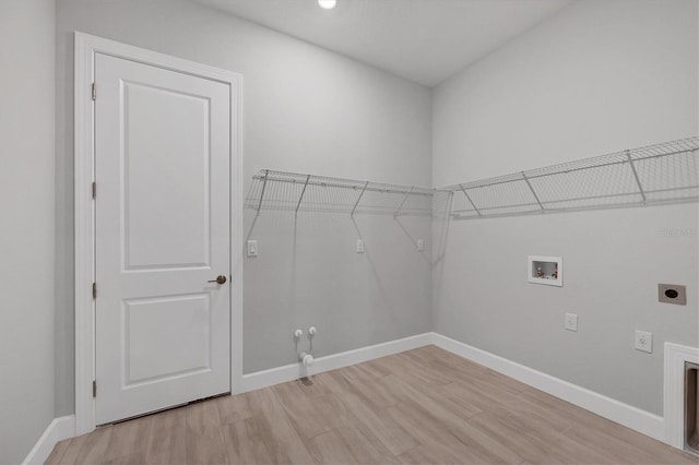 washroom featuring hookup for a washing machine, hookup for a gas dryer, light hardwood / wood-style flooring, and hookup for an electric dryer