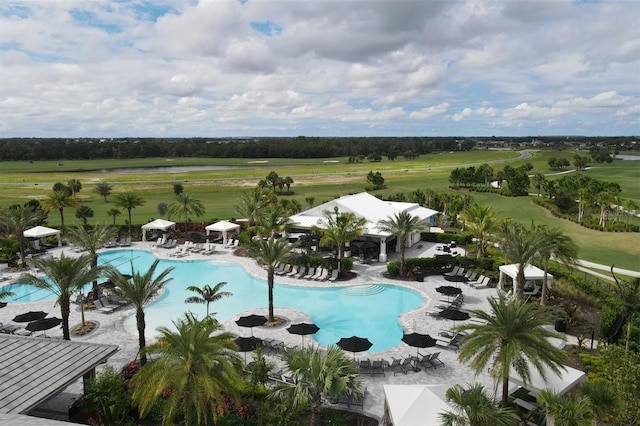 view of swimming pool featuring a rural view and a patio