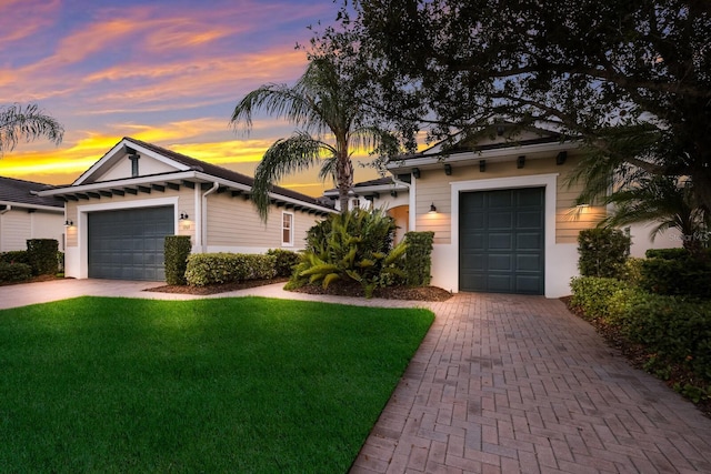 view of front of property featuring a lawn and a garage