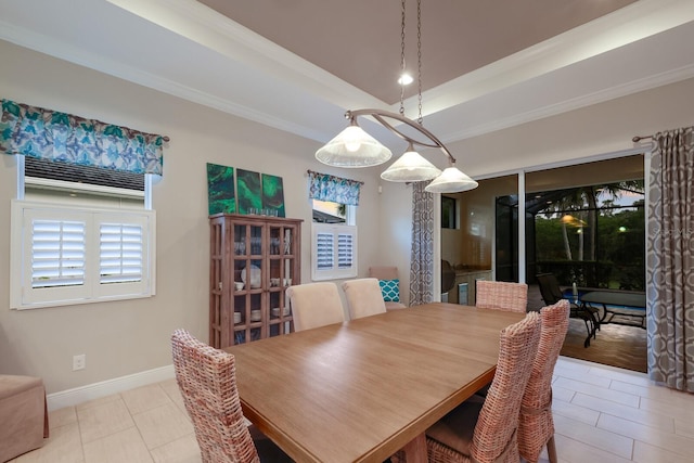 dining area featuring light tile patterned floors, a raised ceiling, and crown molding