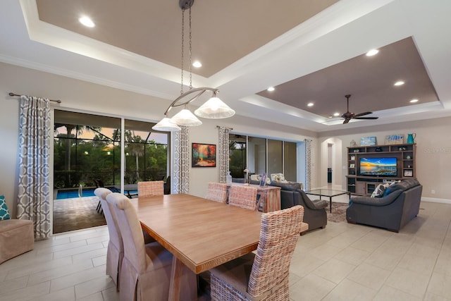 dining room featuring a tray ceiling, ceiling fan, and crown molding