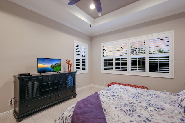 bedroom featuring multiple windows, a raised ceiling, ceiling fan, and crown molding