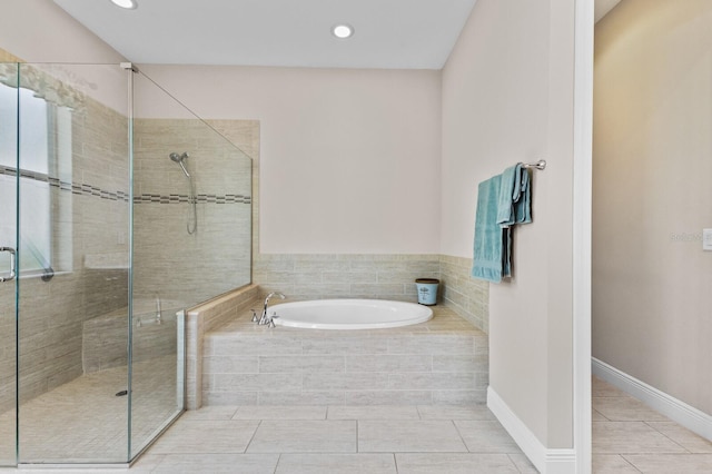 bathroom featuring tile patterned flooring and independent shower and bath