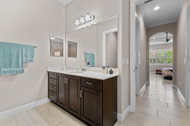 bathroom with vanity, ceiling fan, and crown molding