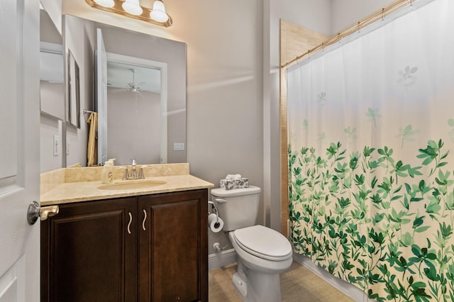 bathroom with ceiling fan, vanity, and toilet