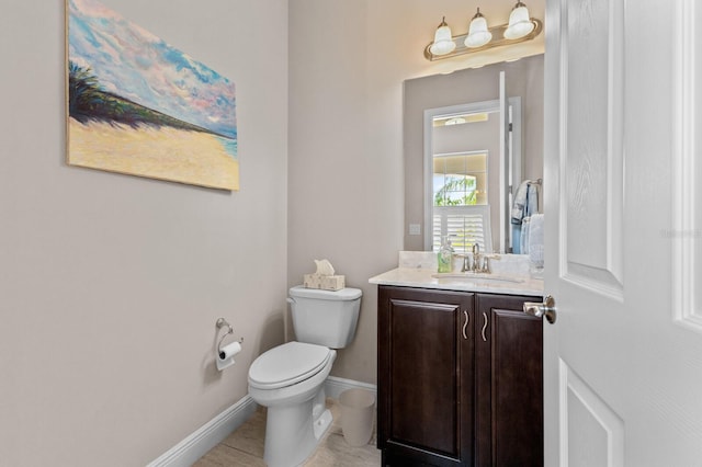 bathroom with tile patterned flooring, vanity, and toilet