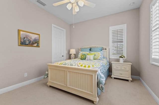 bedroom featuring ceiling fan and light colored carpet