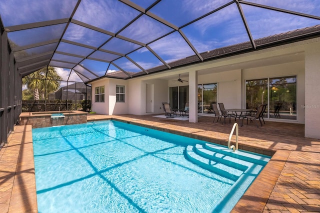 view of pool with ceiling fan, a patio area, a lanai, and an in ground hot tub